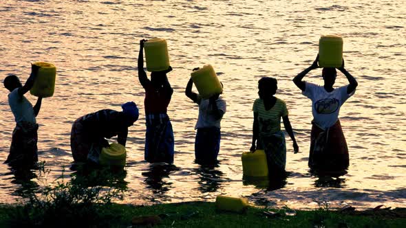 African Women in the Lake at Sunset alt