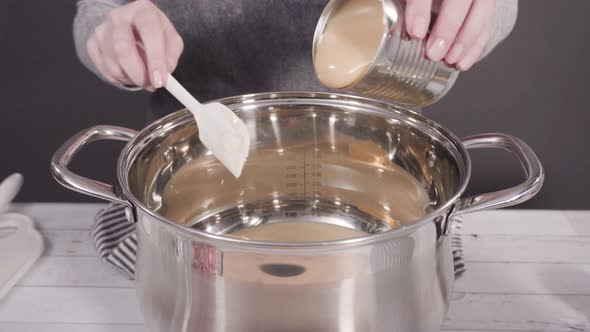 Step by step. Melting white chocolate chips in the cooking pot to make candy cane white chocolate fu alt