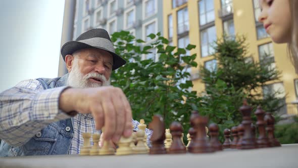 Close Up Concentrated Senior Old Man Playing Chess alt