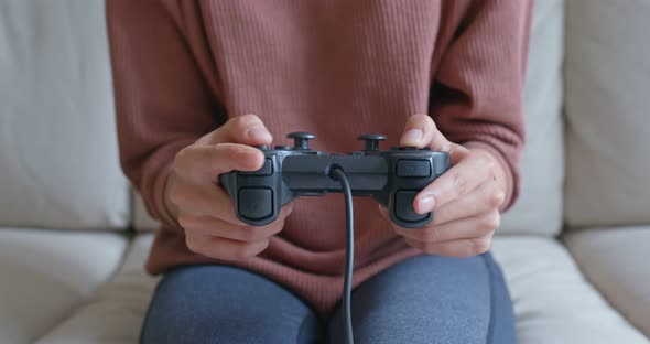 Woman play tv game at home alt