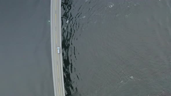 Car Crossing Famous Storseisund Bridge At Atlanterhavsvegen in More and Romsdal, Norway. - Aerial to alt