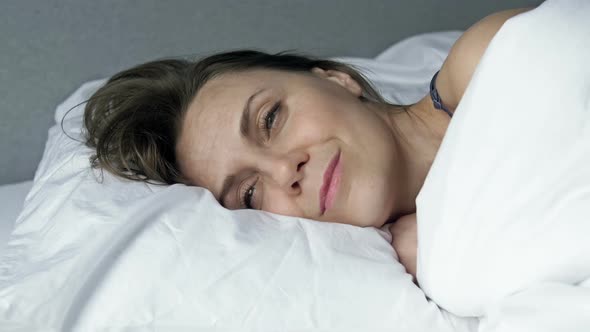 Happy Woman Falls Asleep with a Smile on Her Face