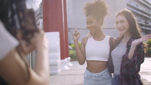 A group of multi-ethnic female friends enjoying the city tour. alt