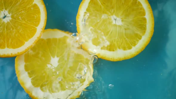Orange Fruit Splashing Into Water