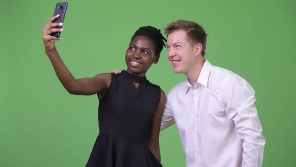 Two Young Multiethnic Business Couple Taking Selfie Together