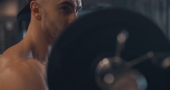 Handsome Strong Athletic Caucasian Men Pumping Up Biceps Muscles with Bar in Gym Workout Fitness and alt