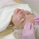 A Gloved Cosmetologist Massages The Skin In A Cosmetology Clinic. Beautician Making Skin Care  - VideoHive Item for Sale