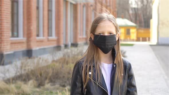 Girl Wearing a Mask Protect Against Coronavirus and Gripp alt