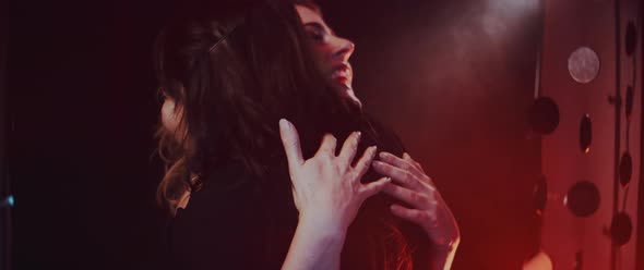 Model and make up artist hugging and laughing alt