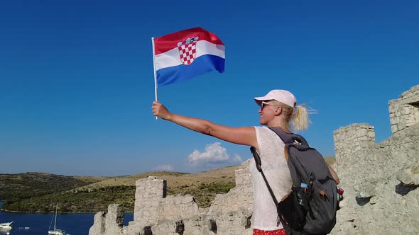 Woman Waving a Croatian Flag on Wall of Ostrica alt