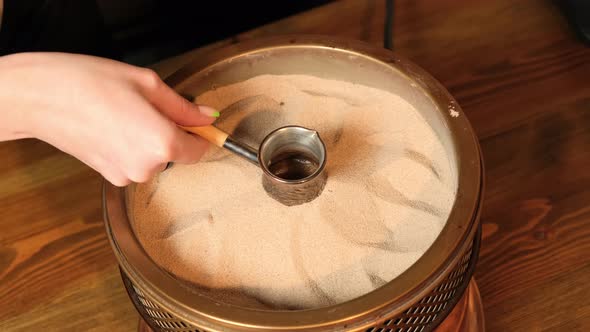 Coffee Turk is Taken Out of the Sand After Boiling Coffee alt