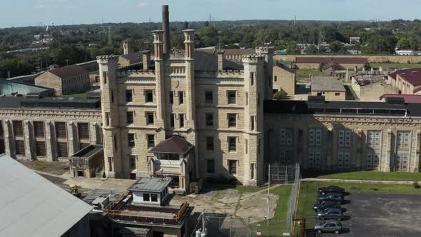 Aerial view of the derelict and abandoned Joliet prison or jail, a historic place. Drone rotating ar alt