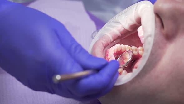 Dentist Conducts Dental Hygiene To the Patient alt