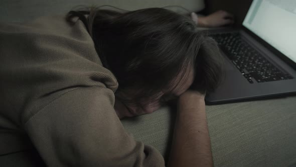 Woman falls asleep while working late at night