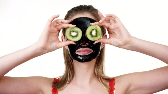 Girl Black Mask Holds Kiwi Fruit