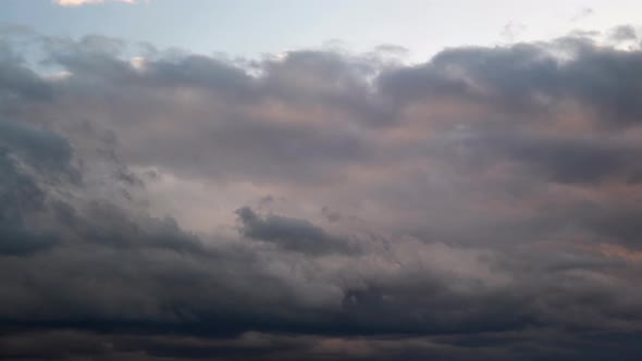 Dark rain clouds in the evening sky, timelapse. Dramatic sky with an coming cloudy cyclone