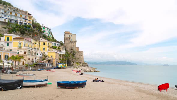 Cetara, Italy. Time lapse video of the beach and old buildings and tower near the sea. alt