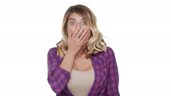 Portrait of Young Woman 30s with Brown Eyes Being Scared Hearing Bad News Covering Mouth with Hands alt