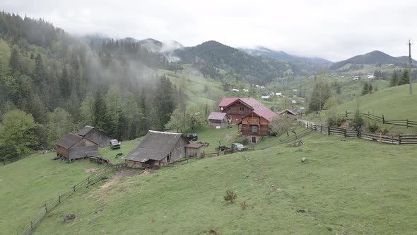 Village in the Mountains. Slow Motion. Carpathians. Ukraine. Aerial. Gray, Flat alt