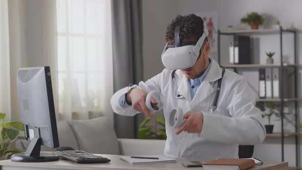 Man Doctor Working in Hospital Office Using Virtual Reality Technology alt