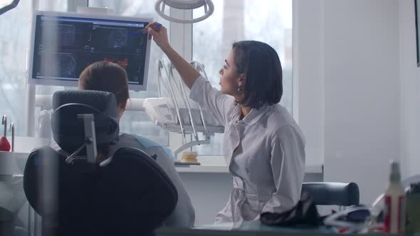 A Female Doctor Discusses with the Patient a Plan for Recovery and Rehabilitation of the Face After alt