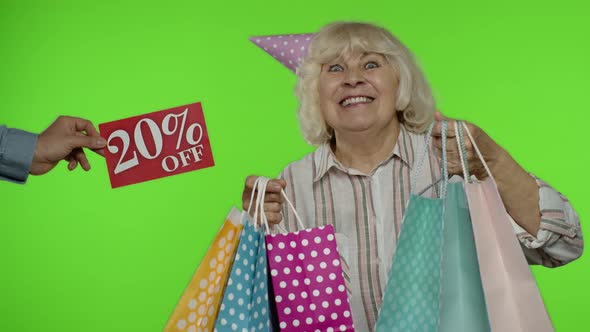 Inscription 20 Percent Off Sale Appears Next To Grandmother. Woman Celebrating with Shopping Bags alt