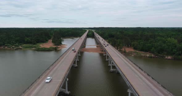 Aerial of cars driving on bridge that crosses over the San Jacinto River in Houston, Texas alt