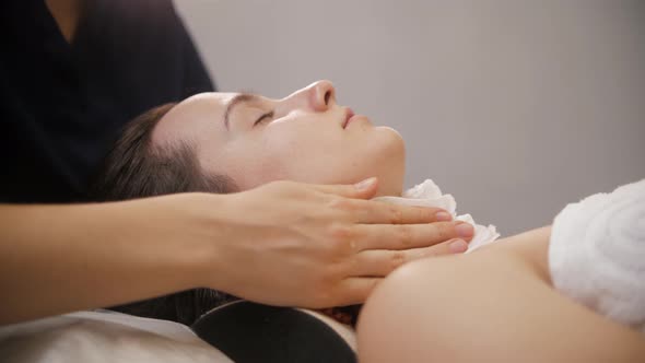 Face Massage  the Massagist Wiping Face of Her Female Client Before the Procedure alt