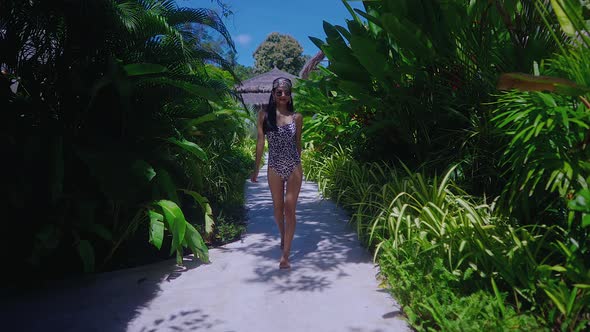 Pretty Girl In Swimming Suit Walking Alone In Resort On Sunny Day in Slow Motion