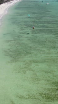 Vertical Video Kitesurfing Near the Shore of Zanzibar Tanzania alt
