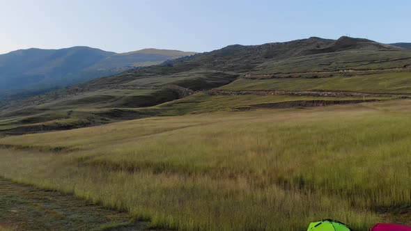 Aerial View of Tourists Who Wake Up and Meet the Sunrise on Rock in Dagestan alt