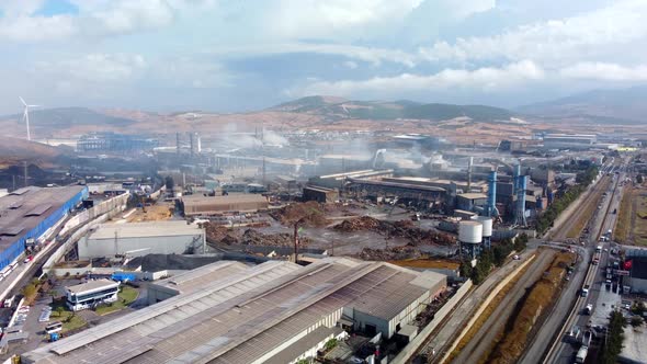 Drone Shot of Industrial Zone with Thick Smog and Burning Fossil Fuels alt