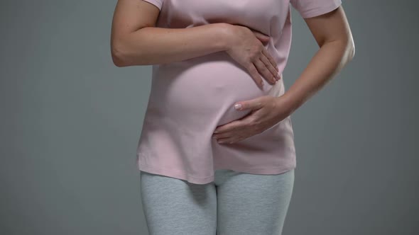 Pregnant Woman Touching Her Belly, Stress Related Uterine Tone, Pushing of Baby