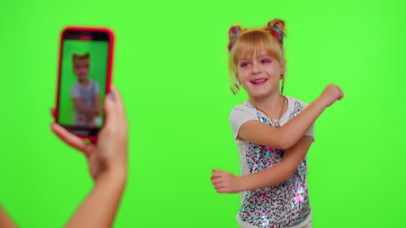 Happy Funky Blogger Child Kid Girl Recording Funny Dancing Video on Smartphone for Social Network alt