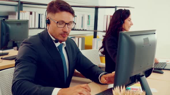 Business People Wearing Headset Working in Office alt