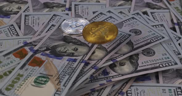 Golden Symbolic Coin Bitcoin on Banknotes of One Hundred Dollars with Exchange Bitcoin Cash for a alt