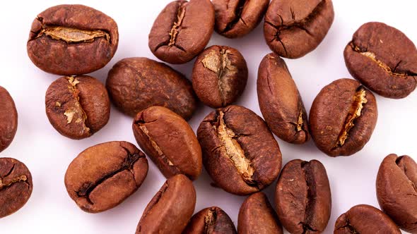 Roasted Ripe Brown Coffee Beans in a Heap Lie on a White Background alt