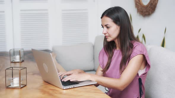 Portrait of Beautiful Woman Sitting in Cafe and Using Laptop for Work  alt