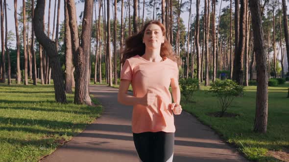 Woman Running in City Park