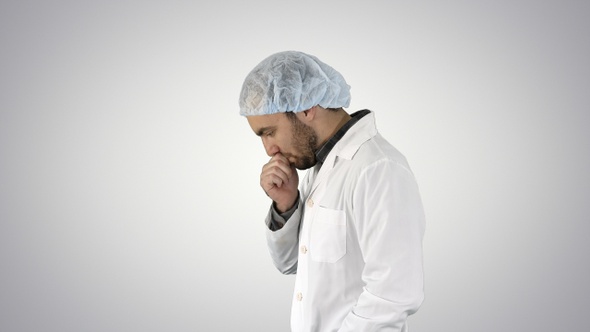 Doctor man walking stressed with hand on head shocked alt