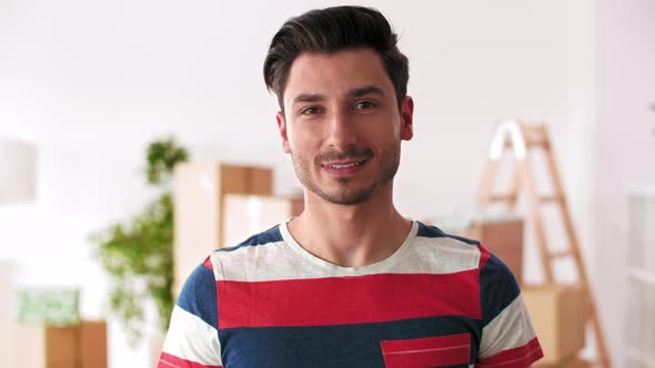 Smiling man holding up new house key alt