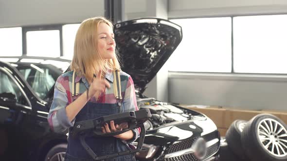 Smiling Happy Girl Enjoying Working at Te Garage alt