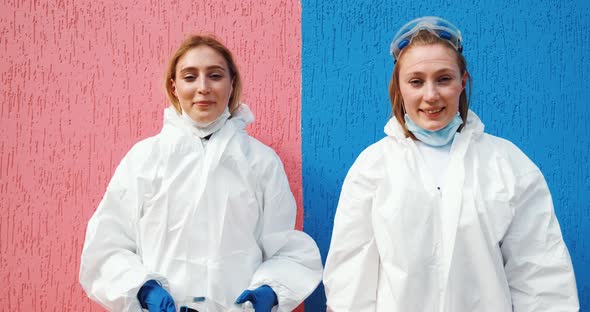 Girls twins work as doctors epidemiologists fighting with coronavirus pandemic. Disinfection workers alt