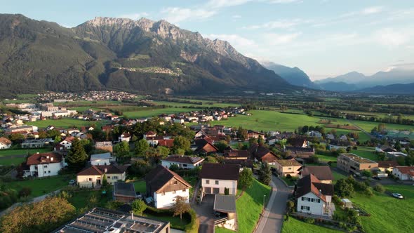 Aerial View of Liechtenstein with Houses on Green Fields in Alps Mountain Valley alt