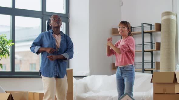 Women with Boxes Moving in New Home and Dancing alt