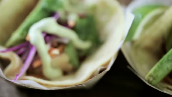 Street fish tacos with cod in recycled paper food tray. alt