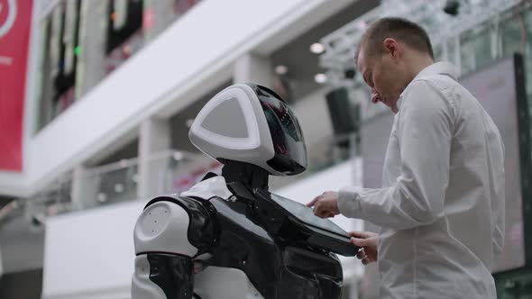 Electronics Engineer Working Scientist Inventor on Robot Construction alt