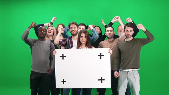 Protest Movement Female Activist Holding a Protest Poster a Protesting Crowd in the Background alt