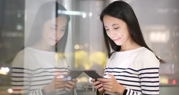 Woman use of smart phone in city alt