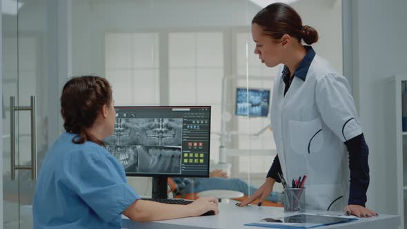 Stomatology Staff Looking at Teeth x Ray Scan alt